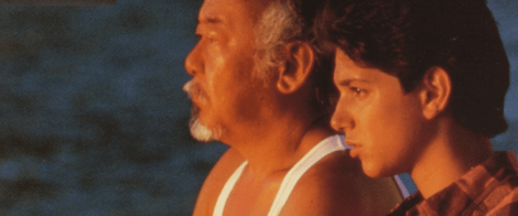 Image: A close-up of an older man and a young man side by side, gazing into the distance with a serene expression, against a soft-focus background that suggests a sunset or soft lighting. The older -- D.C. Douglas