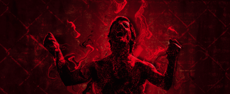 Image: A dynamic image featuring a silhouetted actor surrounded by fiery red smoke against a dark, textured background. The actor's arms are raised, enhancing the dramatic effect. -- D.C. Douglas
