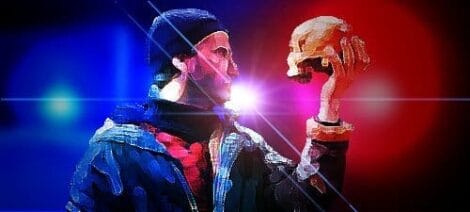 Image: A dramatic digital illustration of an actor in Elizabethan attire holding a skull, with a vivid red and blue spotlight effect in the background. -- D.C. Douglas