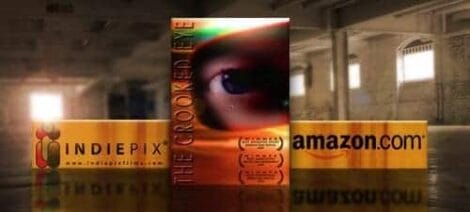 Image: Advertisement banners for "The Crooked Eye" film placed in a large, empty industrial space, featuring various logos including IndiePix and amazon.com. -- D.C. Douglas