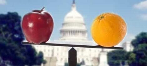 Image: An apple and an orange balanced on a seesaw with the u.s. capitol building blurred in the background, symbolizing comparison or contrast of ideas. -- D.C. Douglas