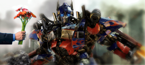 Image: Alt text: a human hand holding a bouquet of colorful flowers extends towards Optimus Prime from the Transformers, depicted in a dynamic battle-ready pose with a blurred background, as a gesture of apologies. -- D.C. Douglas