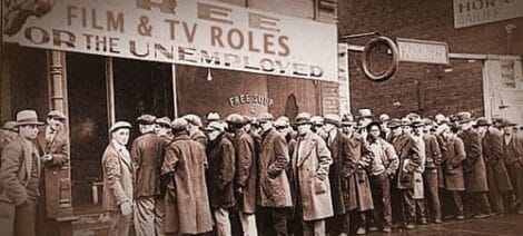 Image: A historical black-and-white photo showing a line of men in coats and hats, queued outside a building offering "film & TV roles for the unemployed. -- D.C. Douglas