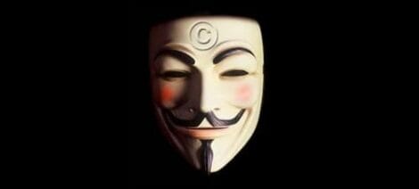 Image: A guy fawkes mask illuminated from the left, casting a shadow on the right side, set against a dark background reminiscent of scenes from streaming movies. The mask features a mischievous smile and -- D.C. Douglas