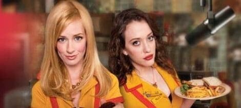 Image: Two women wearing yellow diner uniforms, featured in the TV show "2 Broke Girls," serve food with a background of a busy restaurant kitchen. One smiles holding a burger, the other balances a plate -- D.C. Douglas