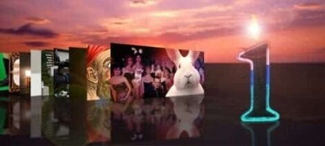 Image: A series of images, including a rabbit and groups of people, displayed in a collage leading to the number one, illuminated in neon blue on a sunset background, celebrating our Blog Anniversary. -- D.C. Douglas