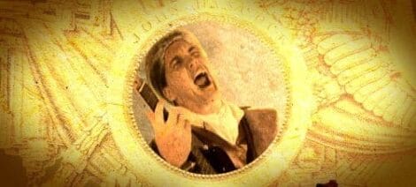 Image: Stylized image featuring a man mid-scream in a circular frame set against a golden background with intricate textures and designs that suggest motion and inspiration. -- D.C. Douglas