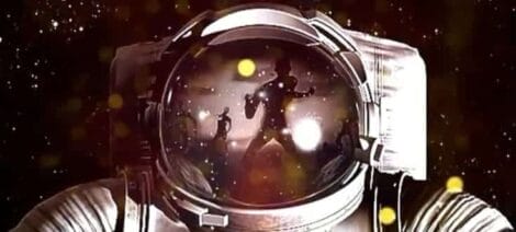 Image: Close-up of an astronaut helmet reflecting the vibrant 2012 event at Zombicon, with bright stars and nebula hues visible in the visor, set against a dark starry background. -- D.C. Douglas