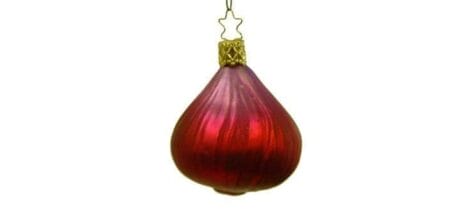 Image: A Christmas ornament shaped like a red onion with a glossy finish and a gold cap, representing the concept that "life is an onion," hanging against a plain white background. -- D.C. Douglas