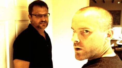 Is Albert Wesker dead? | D.C. Douglas Two men standing in a room, one looking directly at the camera and the other off to the side.