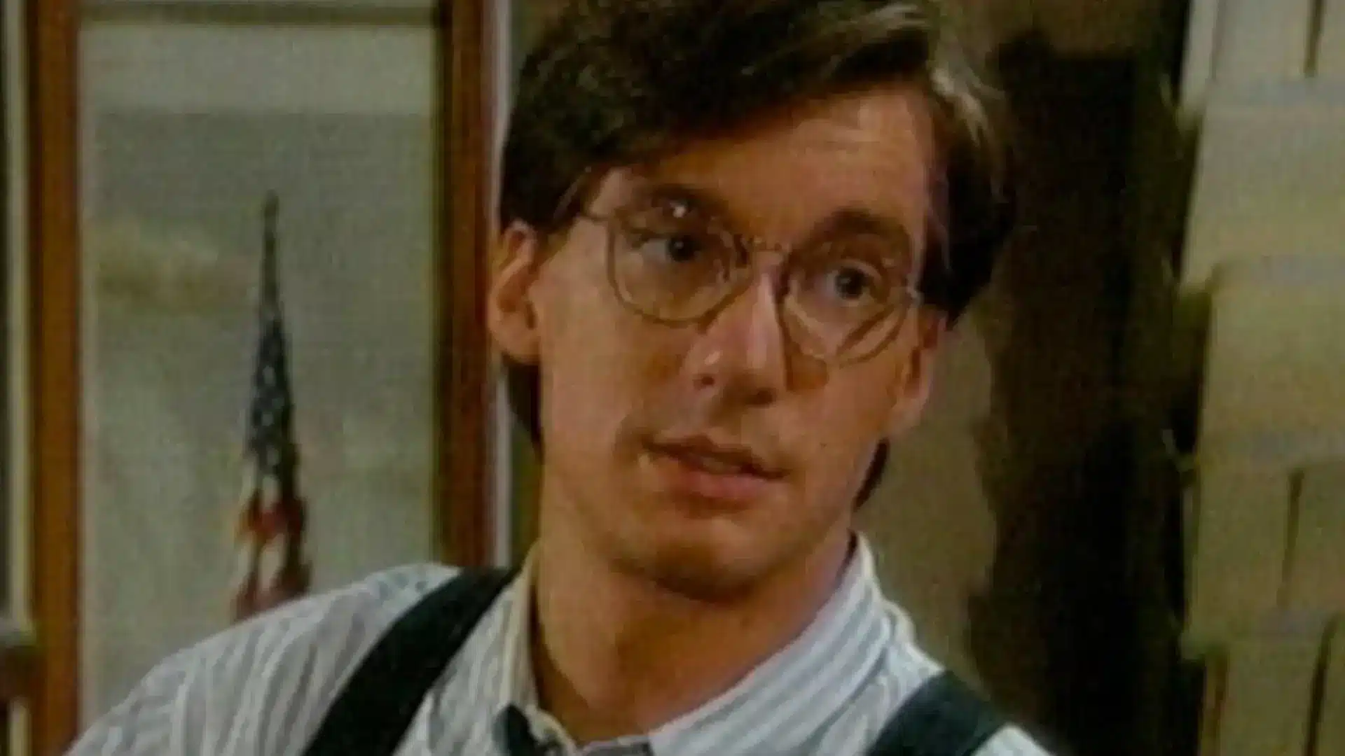 A Bold &Amp; Beautiful Love Letter | D.c. Douglas A young man wearing glasses and suspenders, looking slightly to the side with a neutral expression.