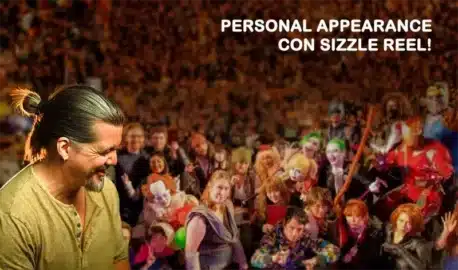 Voice Over Retainers | D.c. Douglas A man smiling with a crowd of people in costumes and makeup at a convention event.