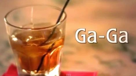 Short Films Library: D.c. Douglas | D.c. Douglas A glass filled with a brown beverage and a straw, labeled 'Ga-Ga'.