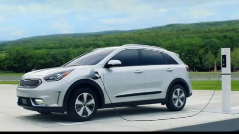 Navigating The Intricacies Of Medical Narration: From Corporate Videos To Patient Education | D.c. Douglas White Kia Niro electric vehicle charging at a station with a scenic background.