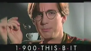 Man with glasses holding a teacup and spoon, looking directly at the camera.