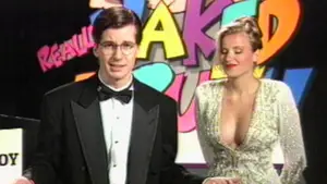 Two television show hosts standing in front of a colorful backdrop with the text 'Naked Truth'.