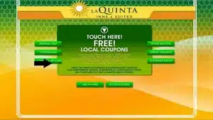 Interactive touchscreen display at La Quinta Inn & Suites with local coupons and navigation options.