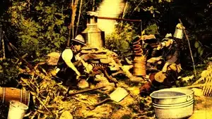 Voice Over: Radio, Streaming, &Amp; Podcast Commercials | D.c. Douglas Two individuals operating a distillation apparatus in a wooded area with various equipment.