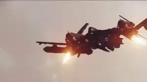Military aircraft launching missiles with visible flames and smoke during flight.