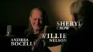 Top 5 Best Commercials Of 2025 | D.c. Douglas Willie Nelson smiling while seated in front of a microphone with Sheryl Crow visible nearby.