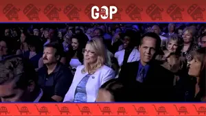 Gadfly: Breaking News &Amp; Tweaked Nipples | D.c. Douglas Audience members seated at a GOP event, including a woman in a white blazer and a man in a dark suit.