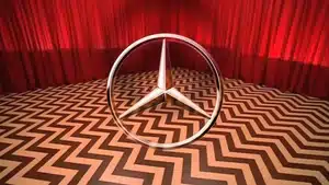 Voice Over: Radio, Streaming, &Amp; Podcast Commercials | D.c. Douglas Three-pointed star logo of Mercedes-Benz placed on a zigzag patterned floor with red curtains in the background.