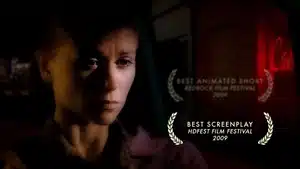 Close-up image of a woman with a serious expression and awards overlay in the corner.