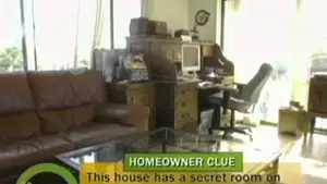 Living room featuring a brown leather sofa, glass coffee table, and a desk with a computer setup.