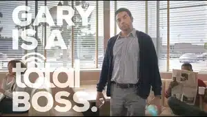 Top 5 Best Commercials Of 2025 | D.c. Douglas A man standing in an office setting with a text overlay that reads 'GARY IS A TOTAL BOSS.'