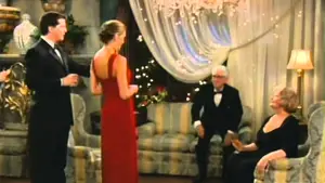 A group of four individuals in formal attire interacting in an indoor setting with decorative elements.