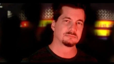 Gadfly: Breaking News &Amp; Tweaked Nipples | D.c. Douglas Portrait of a man with a goatee and short hair in dim red lighting.