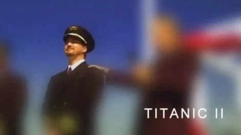 A captain in uniform standing with a blurred background, associated with Titanic II.
